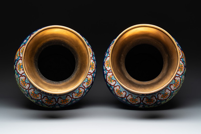 A pair of large Chinese cloisonn&eacute; vases with birds among flowering branches, 20th C.