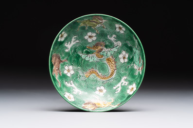 A Chinese verte biscuit 'animals among waves' bowl and a wooden stand, Jiajing mark, Kangxi