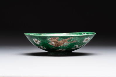 A Chinese verte biscuit 'animals among waves' bowl and a wooden stand, Jiajing mark, Kangxi