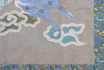 A Japanese embroidered wool and silk wall tapestry with a dragon and qilin, Meiji, 19th C.