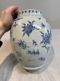 A Chinese blue and white vase with floral design and wooden cover, Transitional period