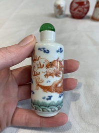 Three Chinese porcelain snuff bottles and a red Peking glass snuff bottle, Daoguang and Tongzhi mark, 19th C.