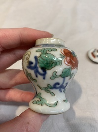A Chinese famille rose seal paste box and a covered jarlet, a miniature wucai vase and a blue and white snuff bottle, Kangxi mark, 19/20th C.