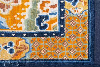 Two Tibetan saddle rugs and three small rugs, 19th C.