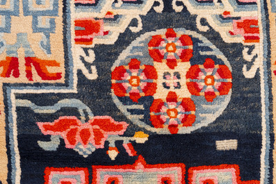 Two Tibetan saddle rugs and three small rugs, 19th C.