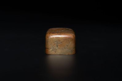 Four Chinese white and spinach-green jade archer rings and a bronze box with a crane design, 19th C.