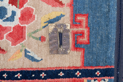 Two Tibetan saddle rugs with floral design, 19th C.