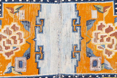 Two Tibetan saddle rugs with floral design, 19th C.