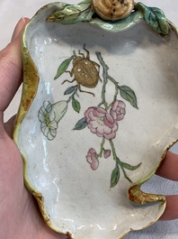 Two Chinese famille rose 'erotic' snuff bottles and a leaf-shaped saucer, 19th C.