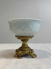 A Chinese white-glazed 'anhua' 'chilong' bowl on gilt bronze stand, 18/19th C.