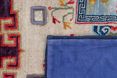 Two Tibetan saddle rugs and three small rugs, 19th C.