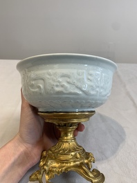 A Chinese white-glazed 'anhua' 'chilong' bowl on gilt bronze stand, 18/19th C.