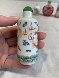 Three Chinese porcelain snuff bottles and a red Peking glass snuff bottle, Daoguang and Tongzhi mark, 19th C.