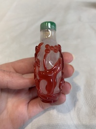 Three Chinese porcelain snuff bottles and a red Peking glass snuff bottle, Daoguang and Tongzhi mark, 19th C.