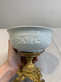 A Chinese white-glazed 'anhua' 'chilong' bowl on gilt bronze stand, 18/19th C.