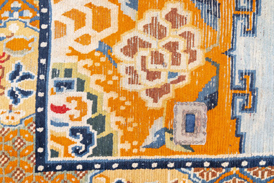 Two Tibetan saddle rugs with floral design, 19th C.