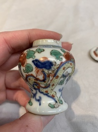 A Chinese famille rose seal paste box and a covered jarlet, a miniature wucai vase and a blue and white snuff bottle, Kangxi mark, 19/20th C.