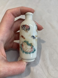 Two Chinese famille rose 'erotic' snuff bottles and a leaf-shaped saucer, 19th C.