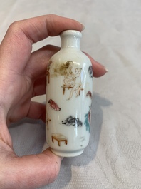 Two Chinese famille rose 'erotic' snuff bottles and a leaf-shaped saucer, 19th C.