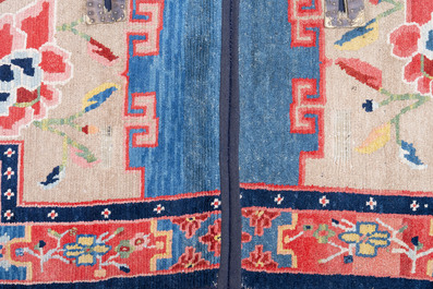 Two Tibetan saddle rugs with floral design, 19th C.