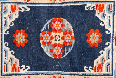 Two Tibetan saddle rugs and three small rugs, 19th C.