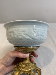 A Chinese white-glazed 'anhua' 'chilong' bowl on gilt bronze stand, 18/19th C.