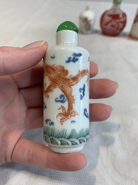 Three Chinese porcelain snuff bottles and a red Peking glass snuff bottle, Daoguang and Tongzhi mark, 19th C.