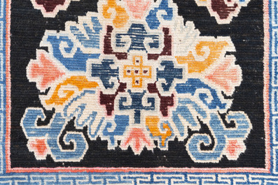 Two Tibetan woollen rugs with floral design, 19th C.