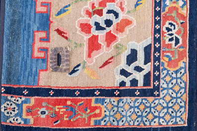 Two Tibetan saddle rugs with floral design, 19th C.