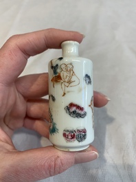 Two Chinese famille rose 'erotic' snuff bottles and a leaf-shaped saucer, 19th C.