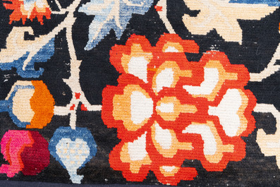 A pair of Tibetan woollen rugs with floral design, 19th C.