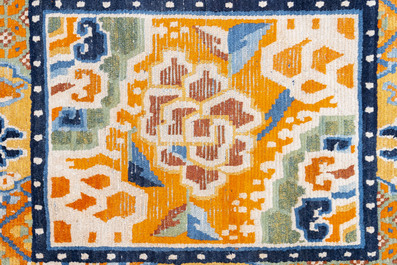 Two Tibetan saddle rugs and three small rugs, 19th C.
