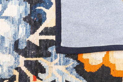 A pair of Tibetan woollen rugs with floral design, 19th C.