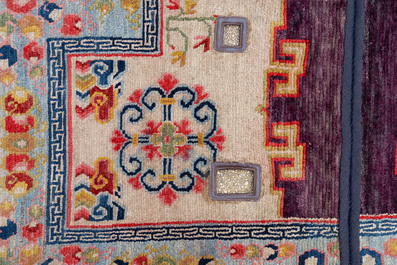 Two Tibetan saddle rugs and three small rugs, 19th C.