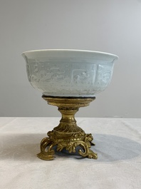 A Chinese white-glazed 'anhua' 'chilong' bowl on gilt bronze stand, 18/19th C.