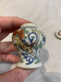 A Chinese famille rose seal paste box and a covered jarlet, a miniature wucai vase and a blue and white snuff bottle, Kangxi mark, 19/20th C.
