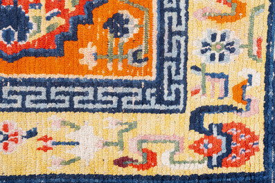 Two Tibetan saddle rugs and three small rugs, 19th C.