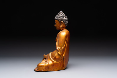 A Chinese gilt-lacquered wooden sculpture of Buddha, Ming