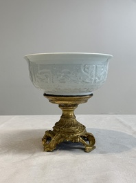 A Chinese white-glazed 'anhua' 'chilong' bowl on gilt bronze stand, 18/19th C.