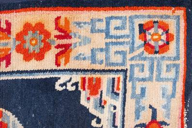 Two Tibetan saddle rugs and three small rugs, 19th C.