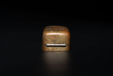 Four Chinese white and spinach-green jade archer rings and a bronze box with a crane design, 19th C.
