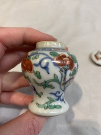 A Chinese famille rose seal paste box and a covered jarlet, a miniature wucai vase and a blue and white snuff bottle, Kangxi mark, 19/20th C.