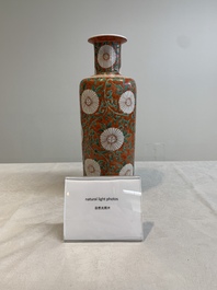 A Chinese famille verte coral-red-ground rouleau vase with flower scrolls, Kangxi