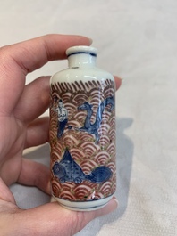 A pair of Chinese blue, white and copper-red 'mythical beasts' and a famille rose 'grasshopper' snuff bottle, Yongzheng and Daoguang mark, 19th C.