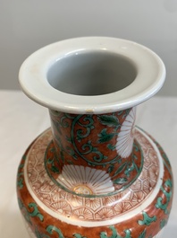 A Chinese famille verte coral-red-ground rouleau vase with flower scrolls, Kangxi
