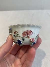 A Chinese famille rose 'rooster' teapot with applied floral design, two cups and a saucer, Yongzheng/Qianlong