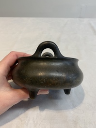 A Chinese bronze tripod censer with wooden cover and stand, Xuande mark, 18/19th C.