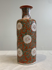 A Chinese famille verte coral-red-ground rouleau vase with flower scrolls, Kangxi
