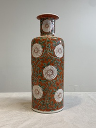A Chinese famille verte coral-red-ground rouleau vase with flower scrolls, Kangxi