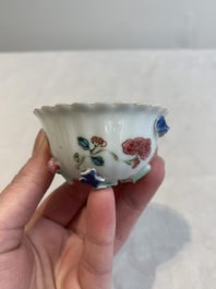 A Chinese famille rose 'rooster' teapot with applied floral design, two cups and a saucer, Yongzheng/Qianlong